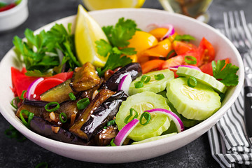 Salad fresh raw vegetables - armenian cucumber, tomatoes, paprika, parsley, red onion and stewed eggplant. Vegan buddha bowl.