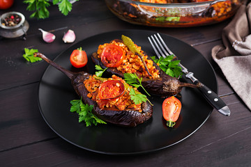 Karniyarik - turkish traditional aubergine eggplant meal. Stuffed eggplants with ground beef and vegetables baked with tomato sauce. Turkish cuisine.