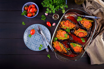 Karniyarik - turkish traditional aubergine eggplant meal. Stuffed eggplants with ground beef and vegetables baked with tomato sauce. Turkish cuisine. Top view. Copy space