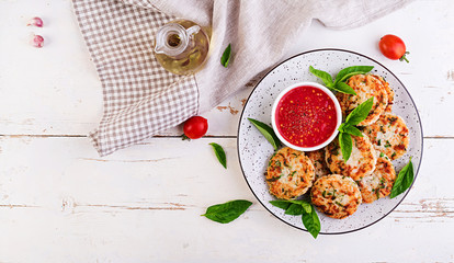 Delicious rice and chicken meat patties with garlic tomato sauce. Top view. Diet food. Copy space