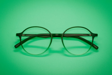 Image of modern fashionable spectacles isolated on green background, Eyewear, Glasses
