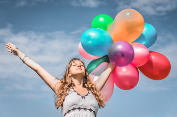 Girl playing with colorful balloons