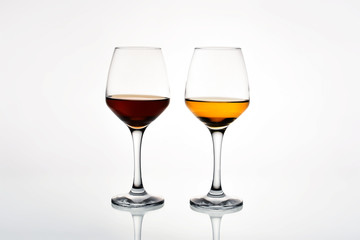 Glass of red and white wine on a white background. Side view.