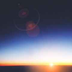 Sunrise from high above the clouds and atmosphere.