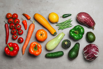 Flat lay composition of different fresh vegetables on grey table