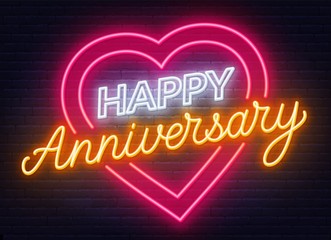 Happy anniversary neon sign. Greeting card on dark background.