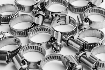 Different metal clamps for hose connection isolated on white background close up