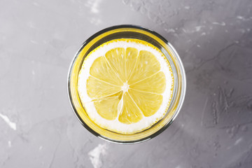 refreshing cocktail. water with lemon top view close-up on grey background