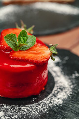 red cake with cream on white plate on wooden table