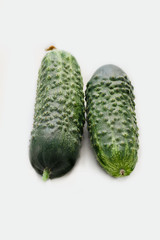 Two fresh green cucumbers isolated on white background