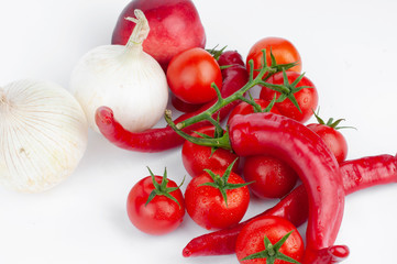 Red tomatoes and peppers on a white background