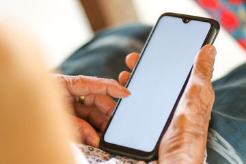 Old woman holding smart phone for shpping online