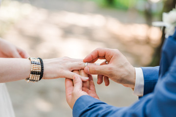 Fototapeta premium Bride and groom putting their wedding rings