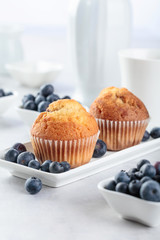 Muffins and blueberry on white table.