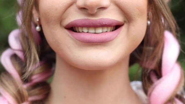 Happy smiling lips in close-up. Unrecognizable woman with pink lips smiling in closeup.