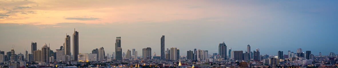 Fototapeta na wymiar Panorama High rise office building The city centre of Bangkok. At dawn, the light from the sky is orange.