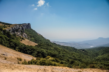 The mountains with a cloud overhead.Landscape of mountains and rocks. Green nature of stone mountain. Natural beauty. Nature of Crimea. Ukraine