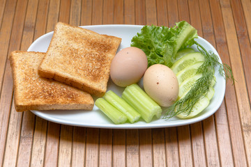 Dietary breakfast, toast, boiled eggs and green vegetables