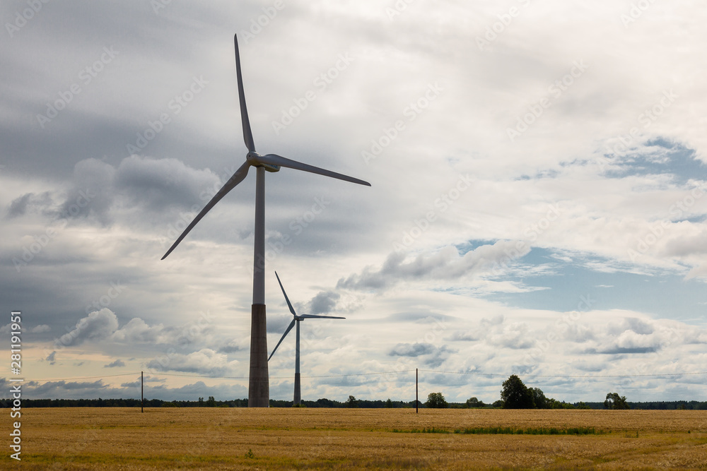 Wall mural Windmill in field at summer 