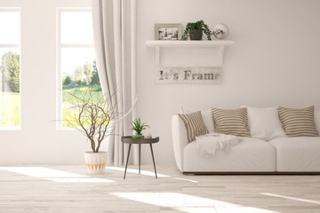 Stylish room in white color with sofa and summer landscape in window. Scandinavian interior design. 3D illustration