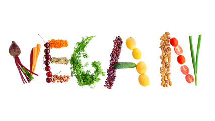 Word 'Vegan' shaped from fruits, vegetables, nuts, and grains. Isolated over white