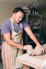 Man creating pottery in his studio