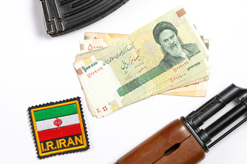 Soviet automaton AK 47 against the backdrop of Iranian money depicting Ruhollah Khomeini and...