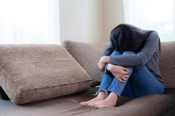 Emotional young woman was depressed on sofa
