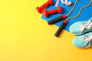 Flat lay composition with healthy lifestyle accessories on color background