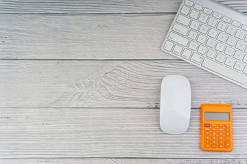 Flat lay, top view office table desk. Workspace with mouse, calculator and keyboard on the wooden background. Business Finance, Education, Technology and Copy Space concept