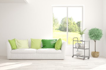 Stylish room in white color with sofa and summer landscape in window. Scandinavian interior design. 3D illustration
