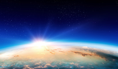 Obraz na płótnie Canvas Earth with sunrise on blue space background