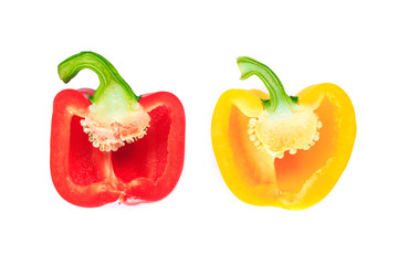red and yellow bell pepper cut half into pieces on white background, top view.
