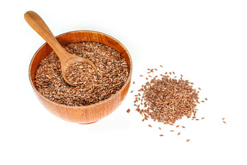 Brown flax seed in bowl and spoon on white background.