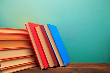  pile of old books panorma, good copy space  on blue background