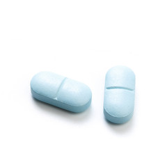 Blue tablets isolated on white background.