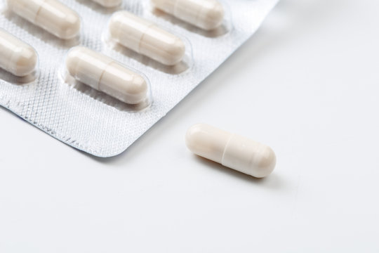 Pile of white capsules probiotic powder inside. Copy space. High resolution product. Health care concept - Image