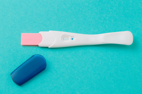 White Plastic Pregnancy Test on blue  Background. - Image