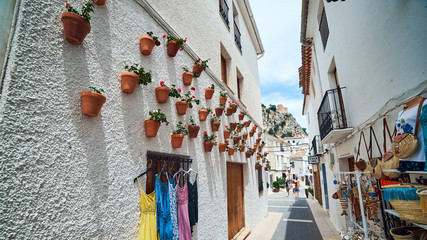 GUADALEST, SPAIN - JUNE 16, 2019: Beautiful flower pots on the walls in Guadalest.