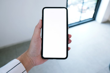 Women's hands holding cell telephone blank copy space screen. smart phone with technology concept.