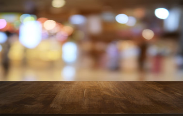 Empty dark wooden table in front of abstract blurred bokeh background of restaurant . can be used for display or montage your products.Mock up for space.