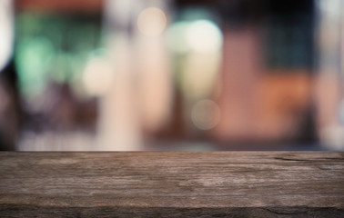 Empty dark wooden table in front of abstract blurred bokeh background of restaurant . can be used for display or montage your products.Mock up for space.