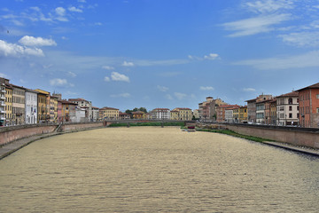 A view from the bridge on the architecture of the city of Pisa in Italy.