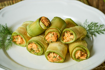 Zucchini rolls with carrots, cheese and fresh herbs