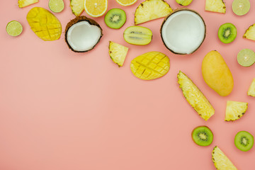 Table top view fruit tropical with spring summer holiday & vacation  background concept.Arrangement sliced various pineapple kiwi mango lemon and lime coconut on  pink paper.flat lay & copy space.