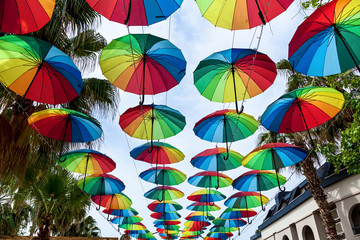 Fototapeta na wymiar Colourful umbrellas danging the street