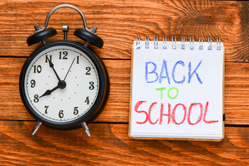 back to school inscription on wooden background, back to school concept