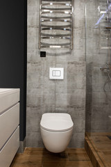 Modern bathroom interior with glass shower cubicle, toilet and wood wall and floor, copy space