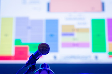 Business people talking on seminar panel with microphone