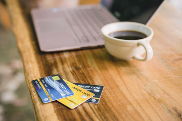 credit card on laptop with coffee, outdoor
